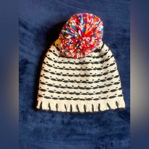 White and black beanie with rainbow puff